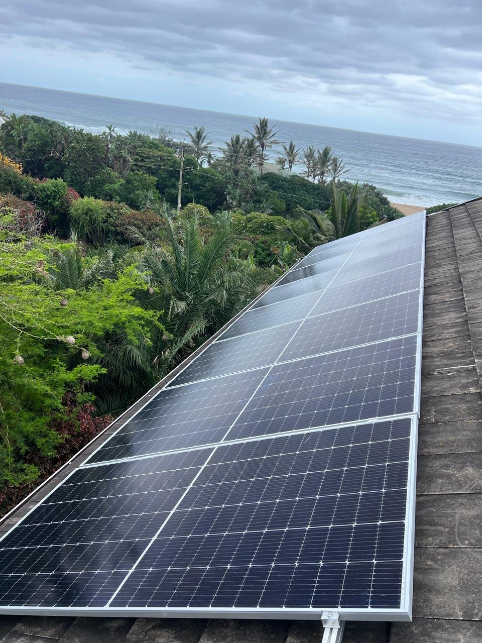 Rooftop solar panel installation on a coastal property.